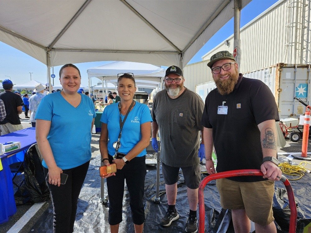 Nate and Greg with event staff under the tent at a Boeing employee event