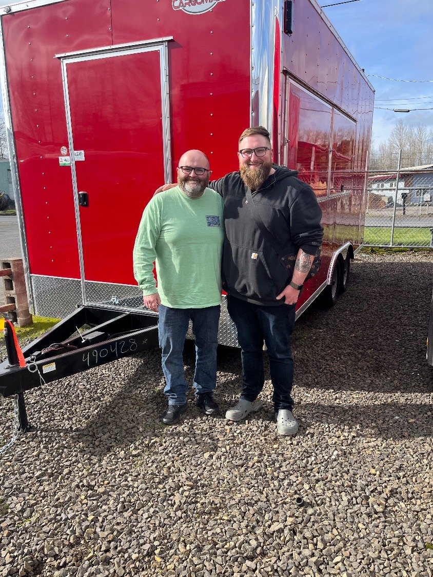 Nate and his dad Greg in front of their very first popcorn trailer, before it was built out