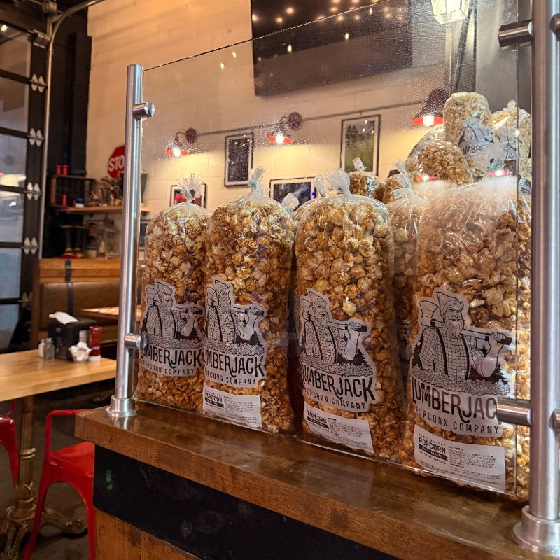 Bags of Lumberjack Salted Caramel popcorn on display at a restaurant counter