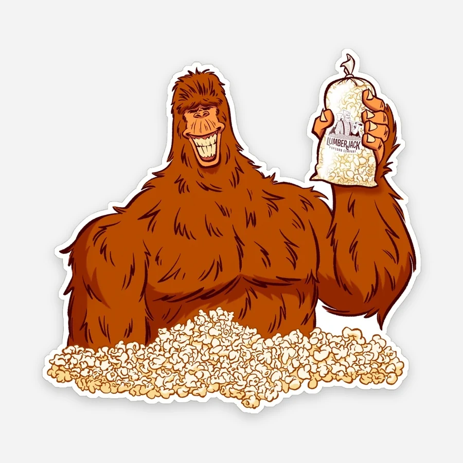 Bigfoot raising a bag of Lumberjack Popcorn, one of our stickers